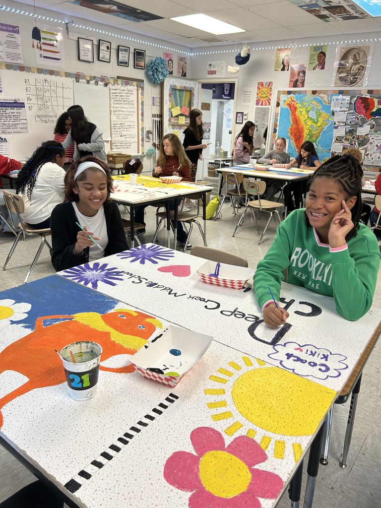two students painint deep Creek Middle tiles!