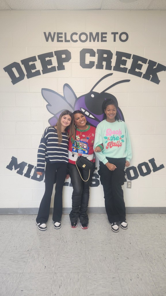 two students and a teacher wearing holiday shirts and socks
