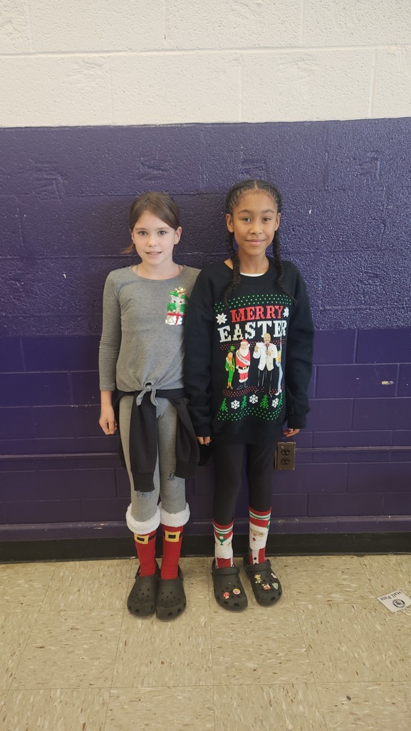 two students wearing a holiday shirt and socks