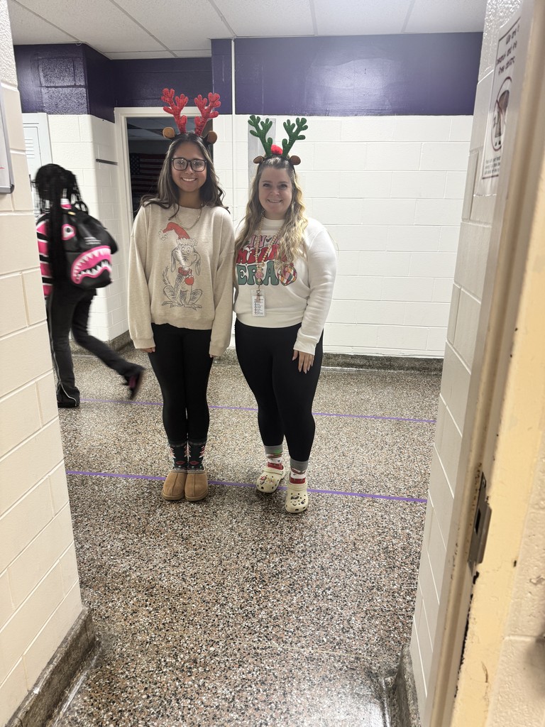 A teacher and students wearing holiday shirt and socks