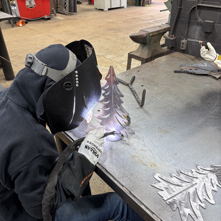 welding students fabricating trees