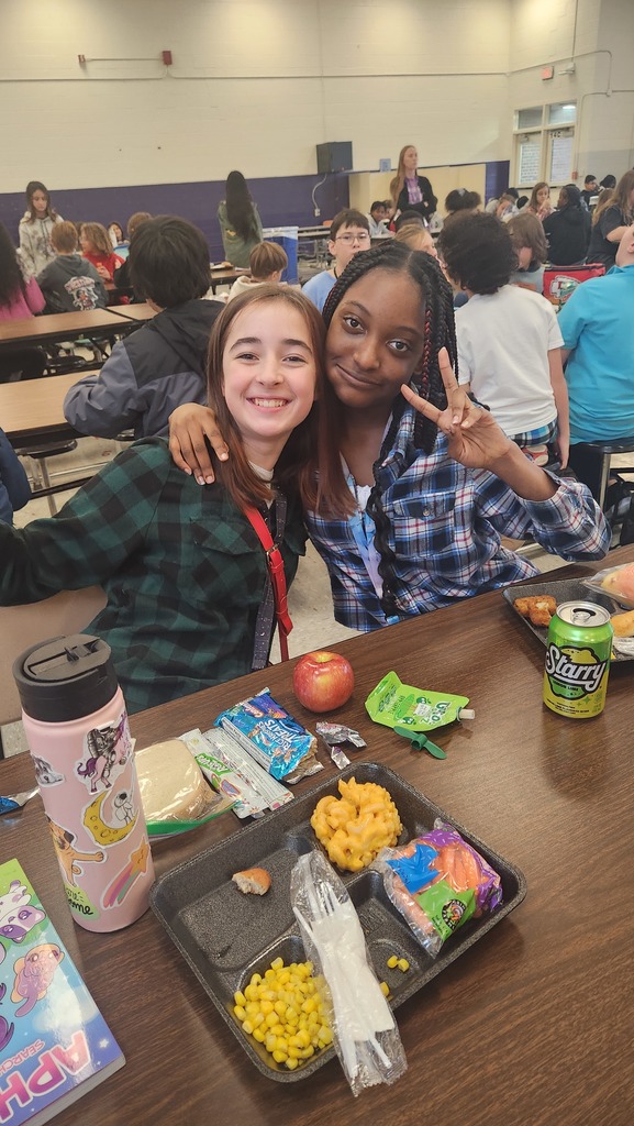 Two students wearing a flannel shirts