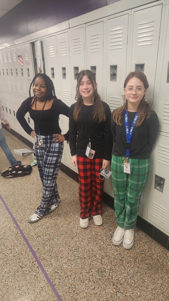 three students wearing flannel pants.