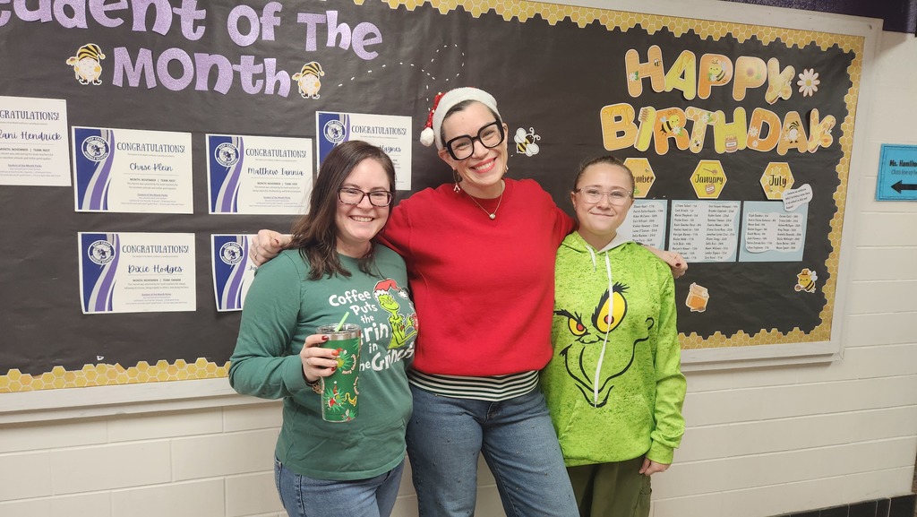 Two teachers and a students sporting their red and green for spirit day!