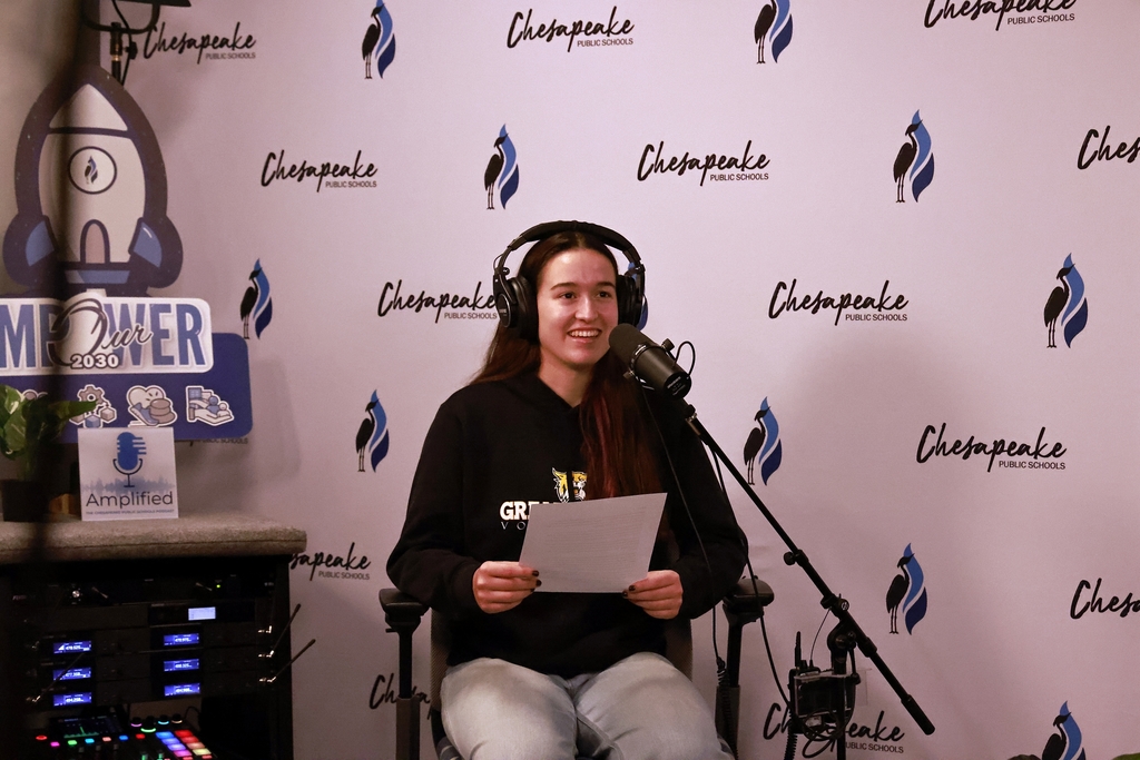 Marcy speaking into the mic.