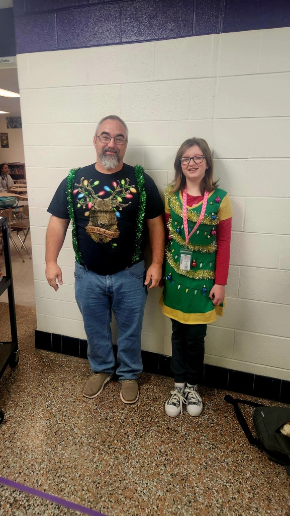 A teacher and a student wearing their holiday bling!