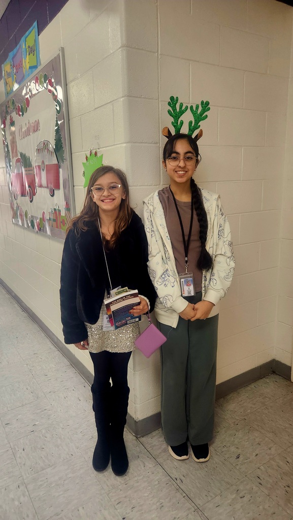 Two students decked out in sparkly holiday outfits
