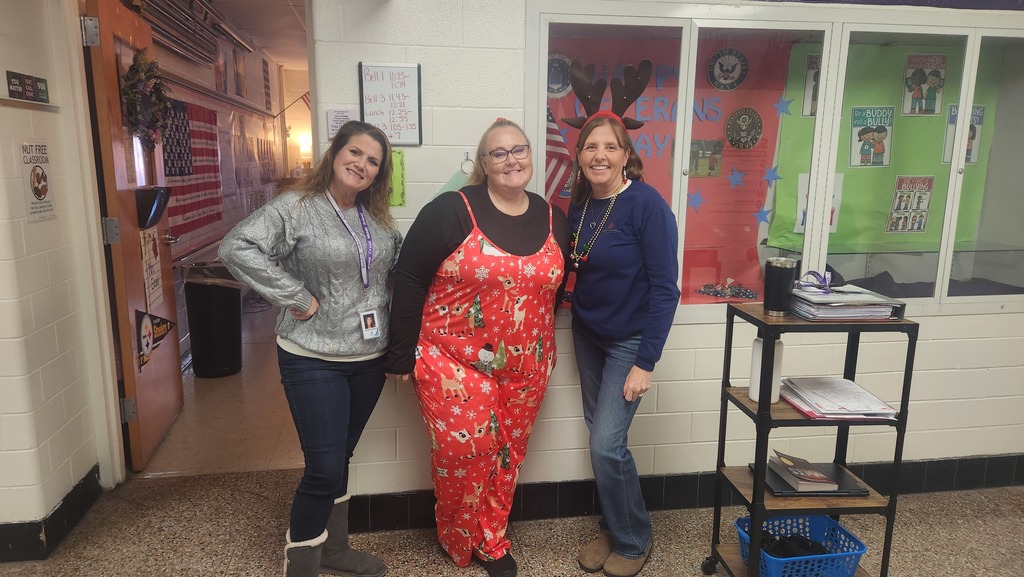 Three teachers wearing a their most festive holiday outfits