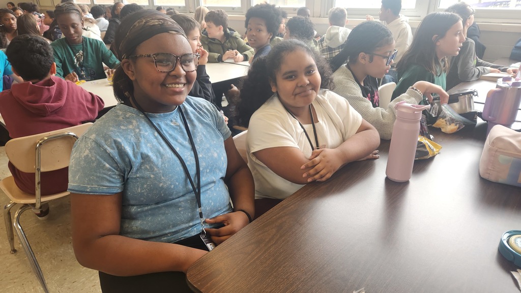 Two students wearing a blue and white