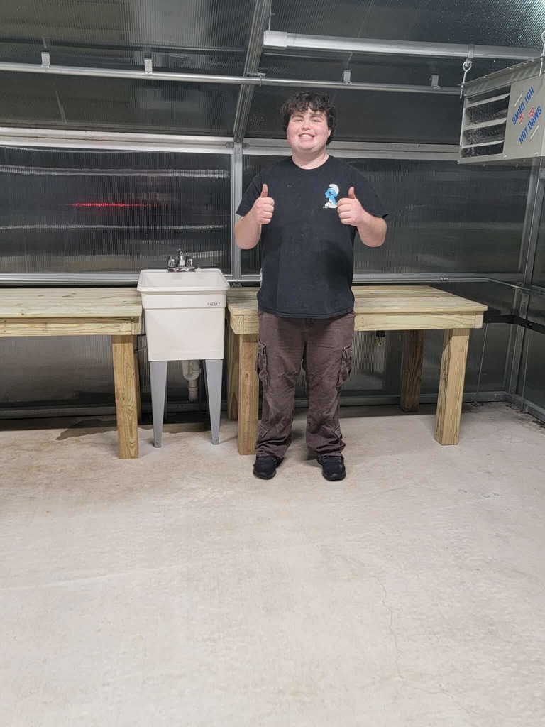 student in the greenhouse with his sink