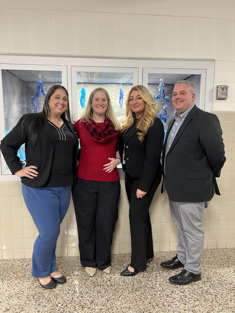 group of 4 adults  posing with smiles 