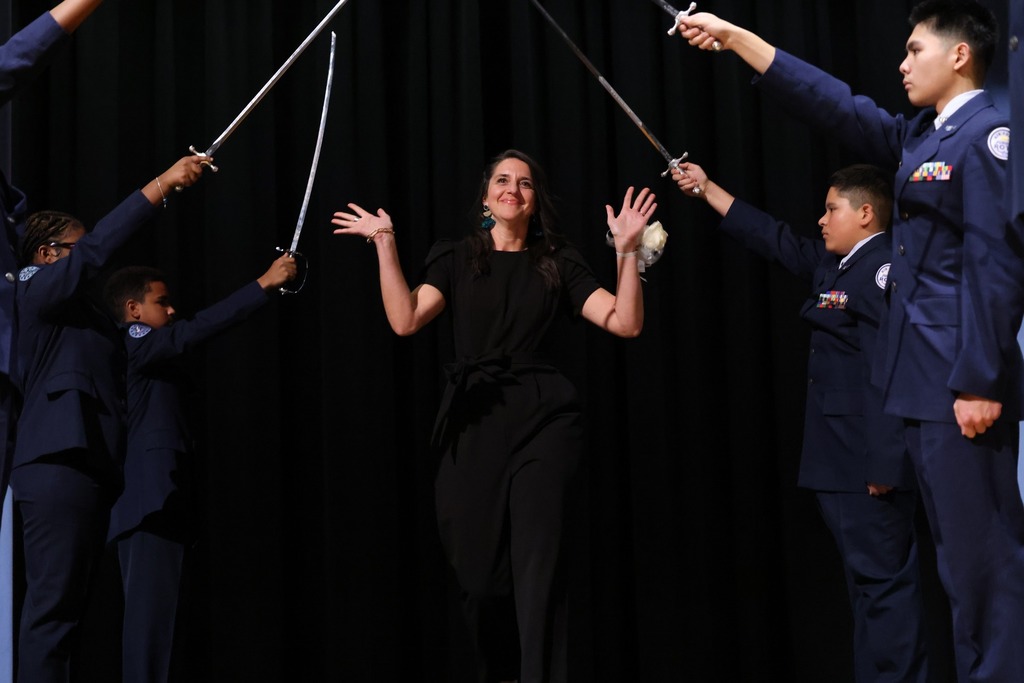 female toy smiling and waving to camera