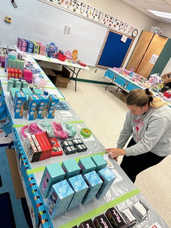 Staff setting up Penguin Patch Holiday Shop