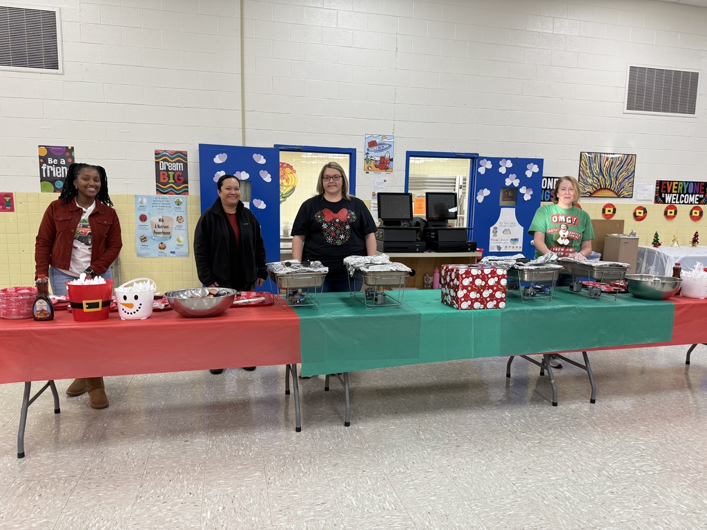Staff members serving breakfast