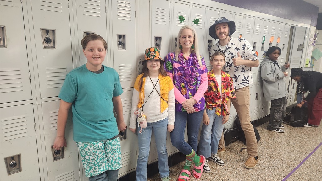 Three students and two teachers wearing a holiday spirit wear!
