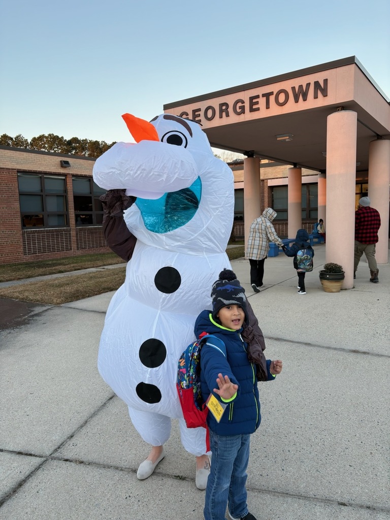 Mrs. Gurkin dressed as Olaf welcoming student to school