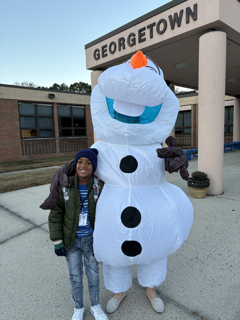 Mrs. Gurkin dressed as Olaf welcoming student to school