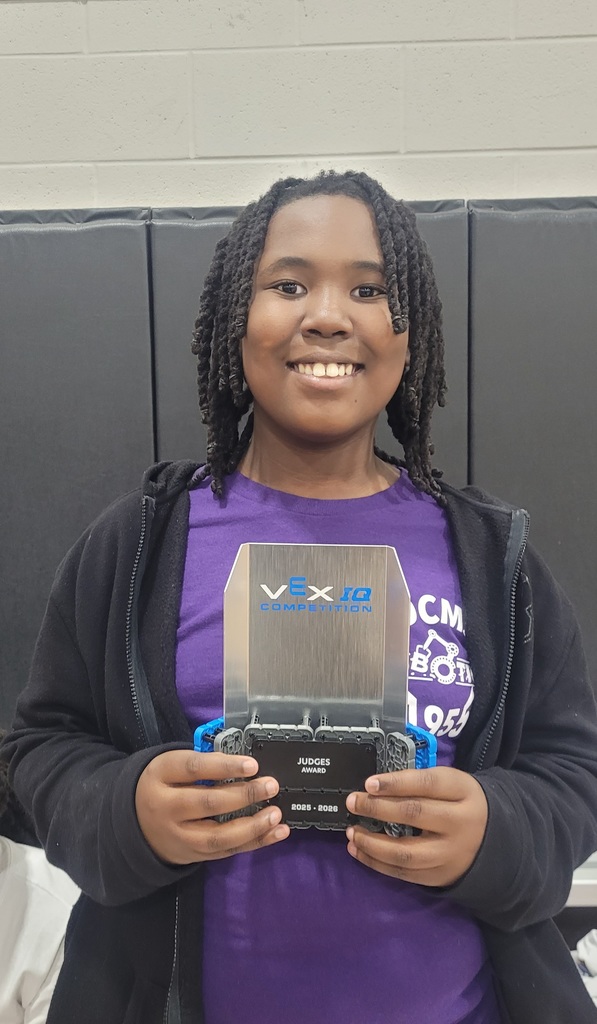 student holding a VEX-IQ judges award