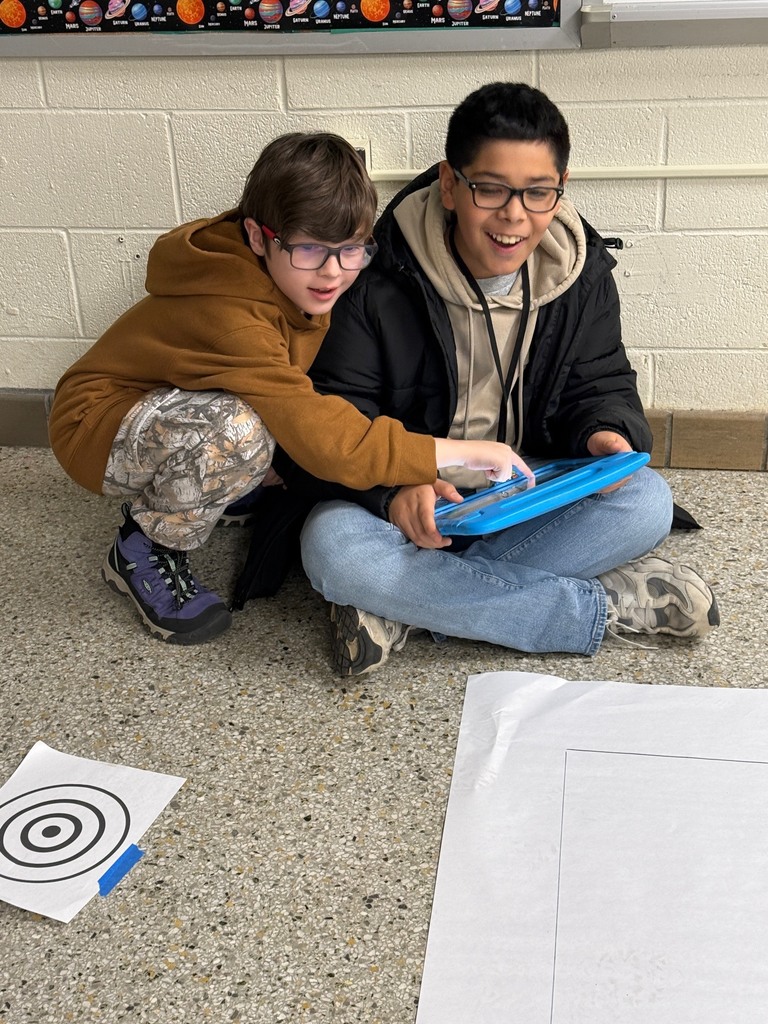 Two students using an iPad to code their Sphero.