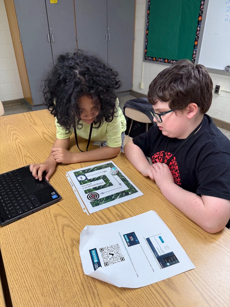 Students watching their Ozobot travel around their maze.