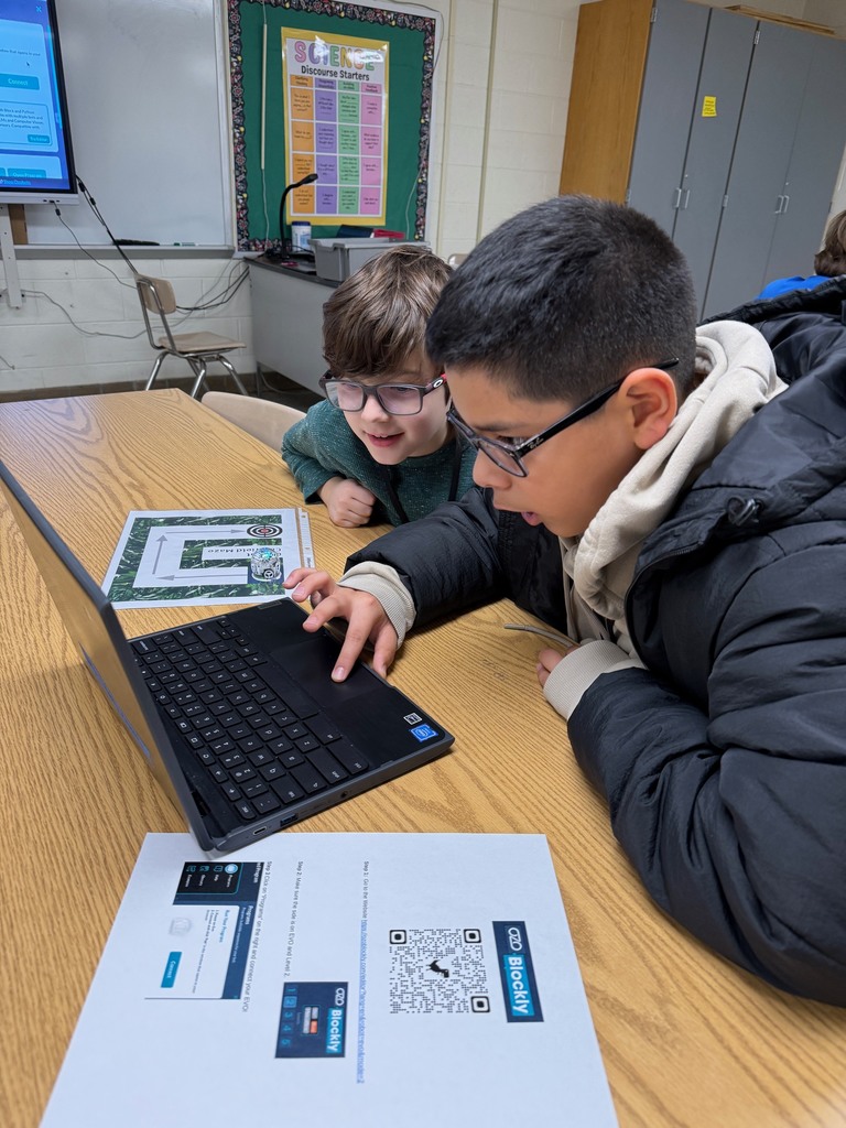 Two students online to code their Ozobot on a computer