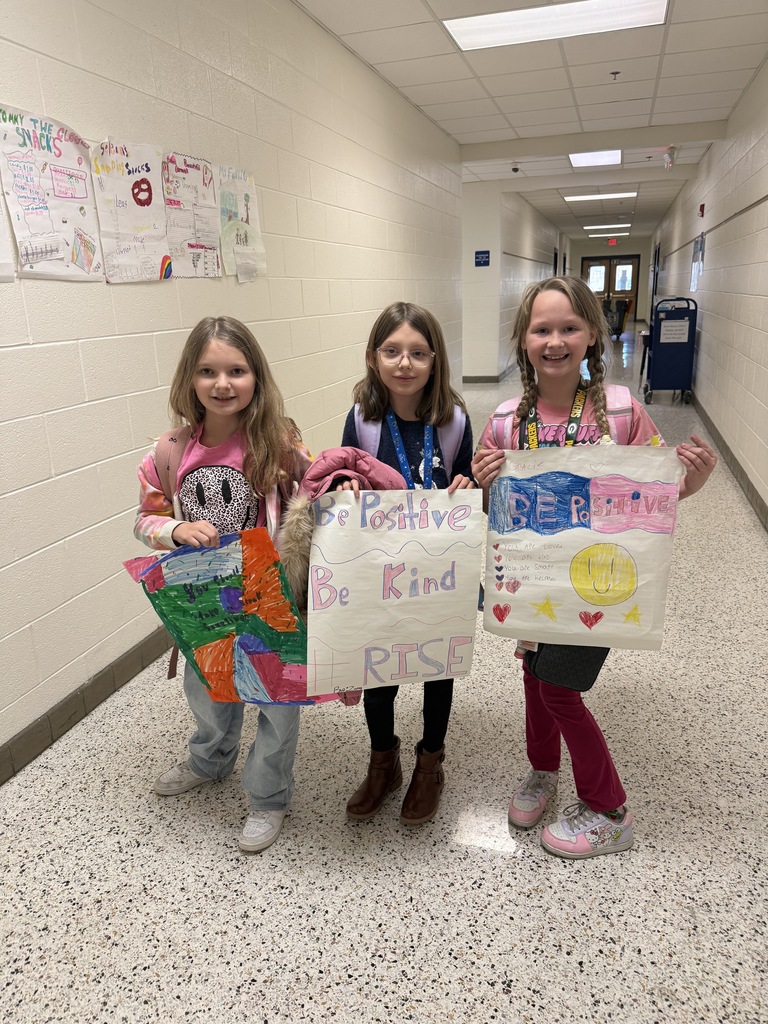Three student from RISE Club with posters