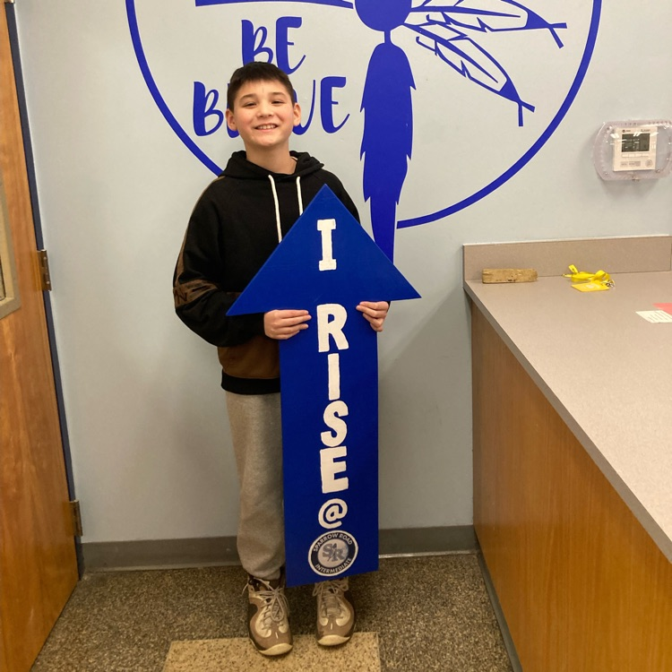 Student with I RISE sign 