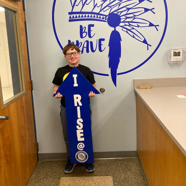 Student with I RISE sign 