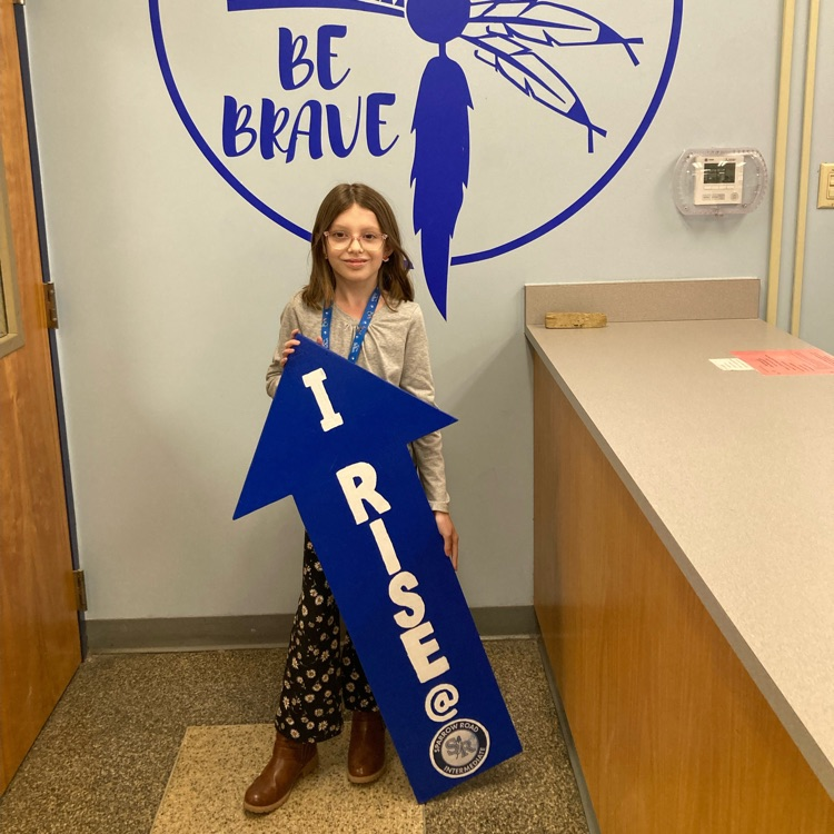 Student with I RISE sign 