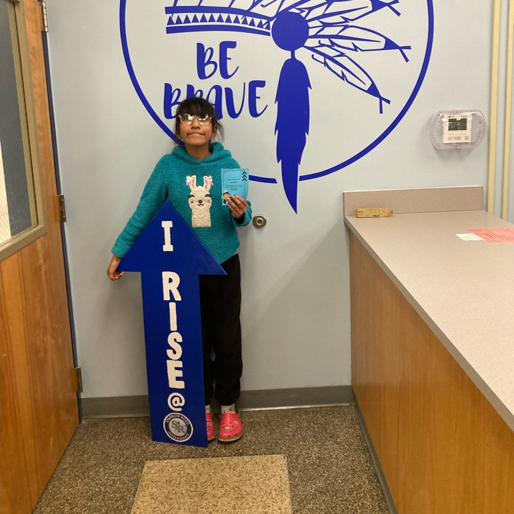 Student with I RISE sign 