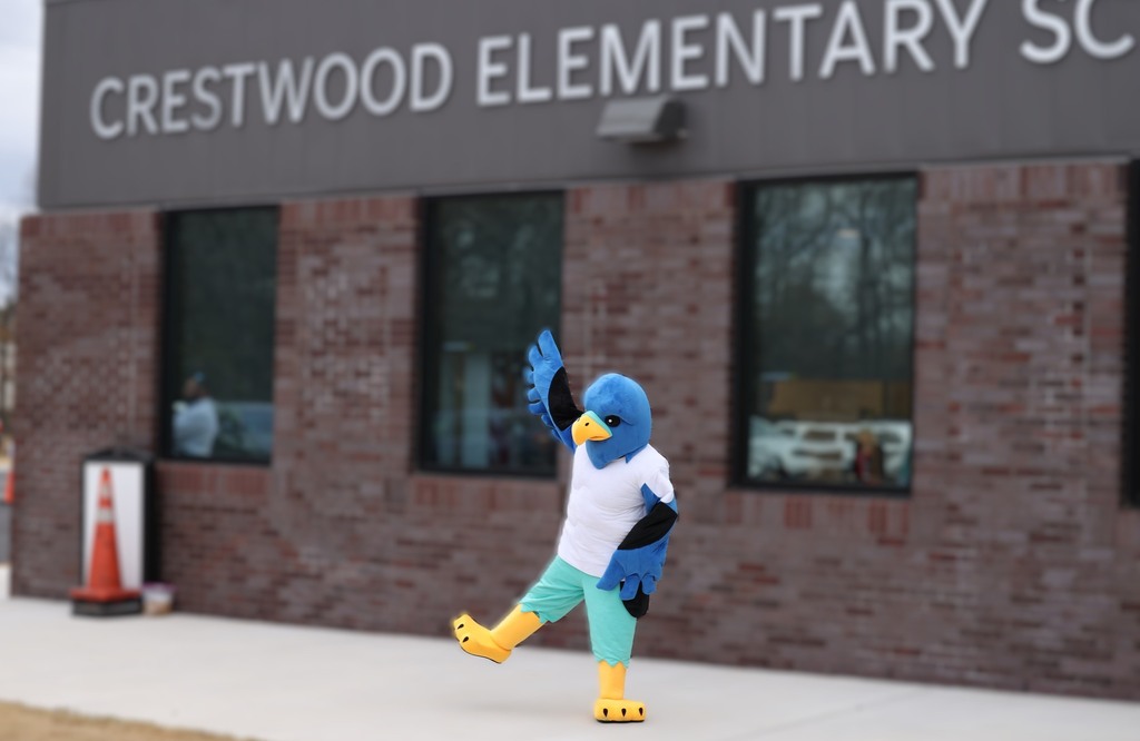 Crestwood falcon dancing in front of school