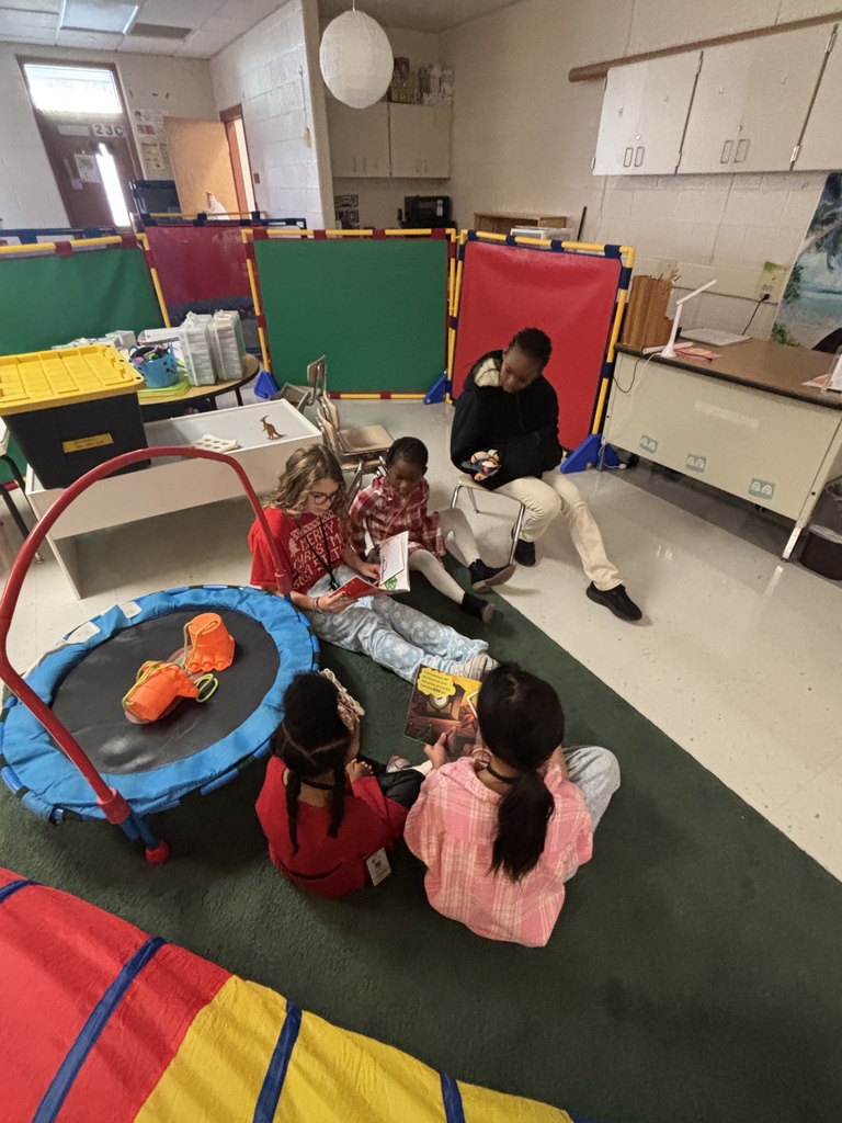 Mrs. May's reading buddies reading Christmas stories to their Kindergarten buddies in Mrs. Escobedo's class