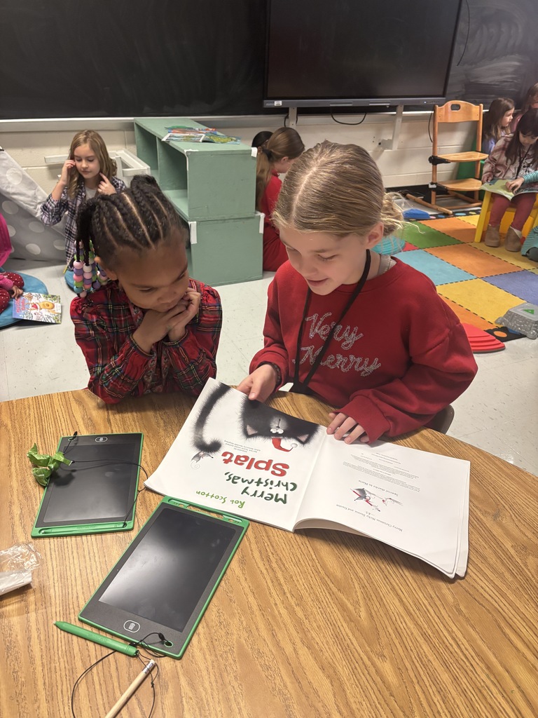 Mrs. May's reading buddies reading Christmas stories to their Kindergarten buddies in Mrs. Escobedo's class