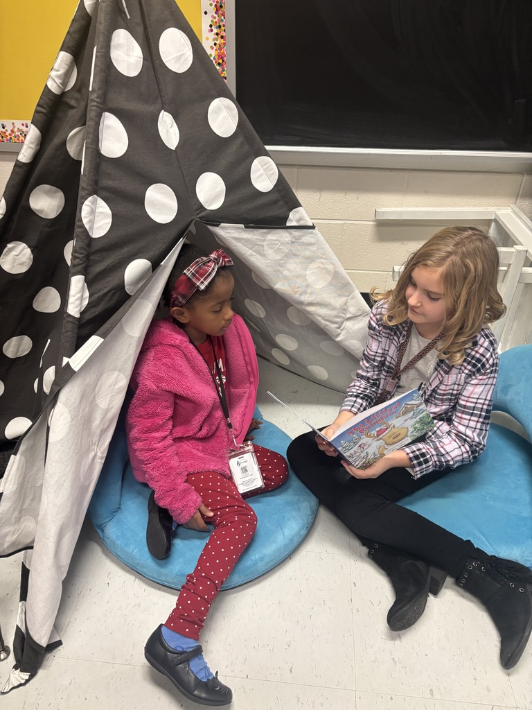 Mrs. May's reading buddies reading Christmas stories to their Kindergarten buddies in Mrs. Escobedo's class