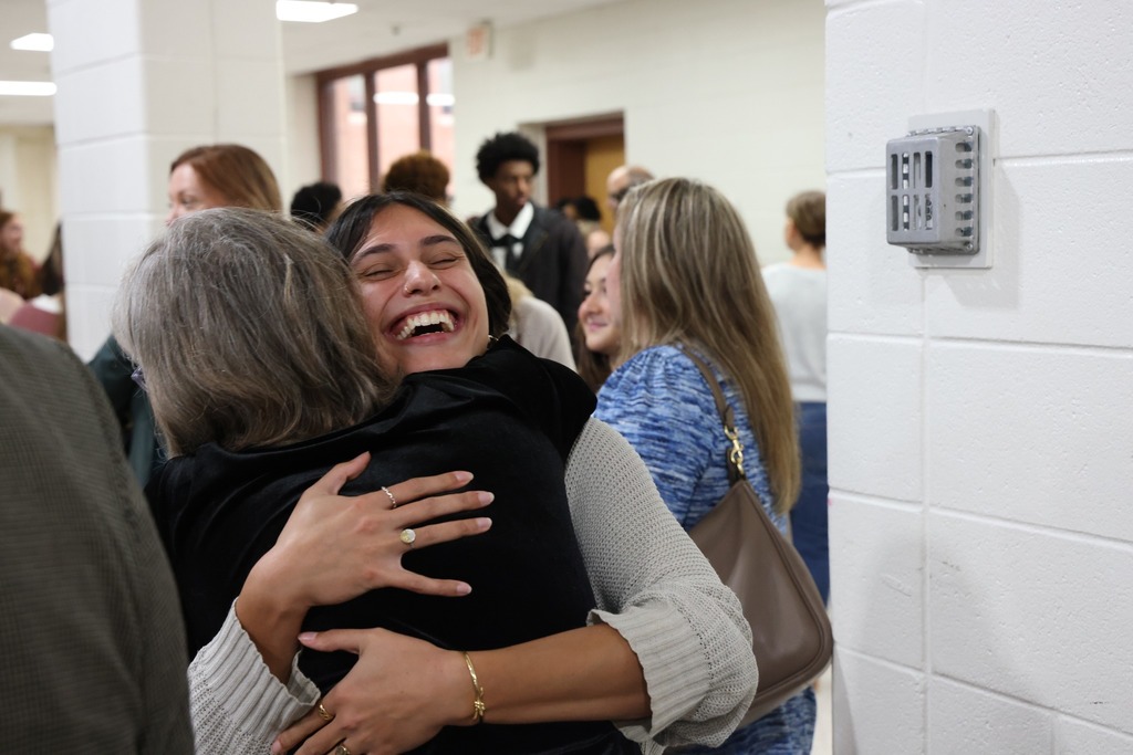 Student hugging teacher.