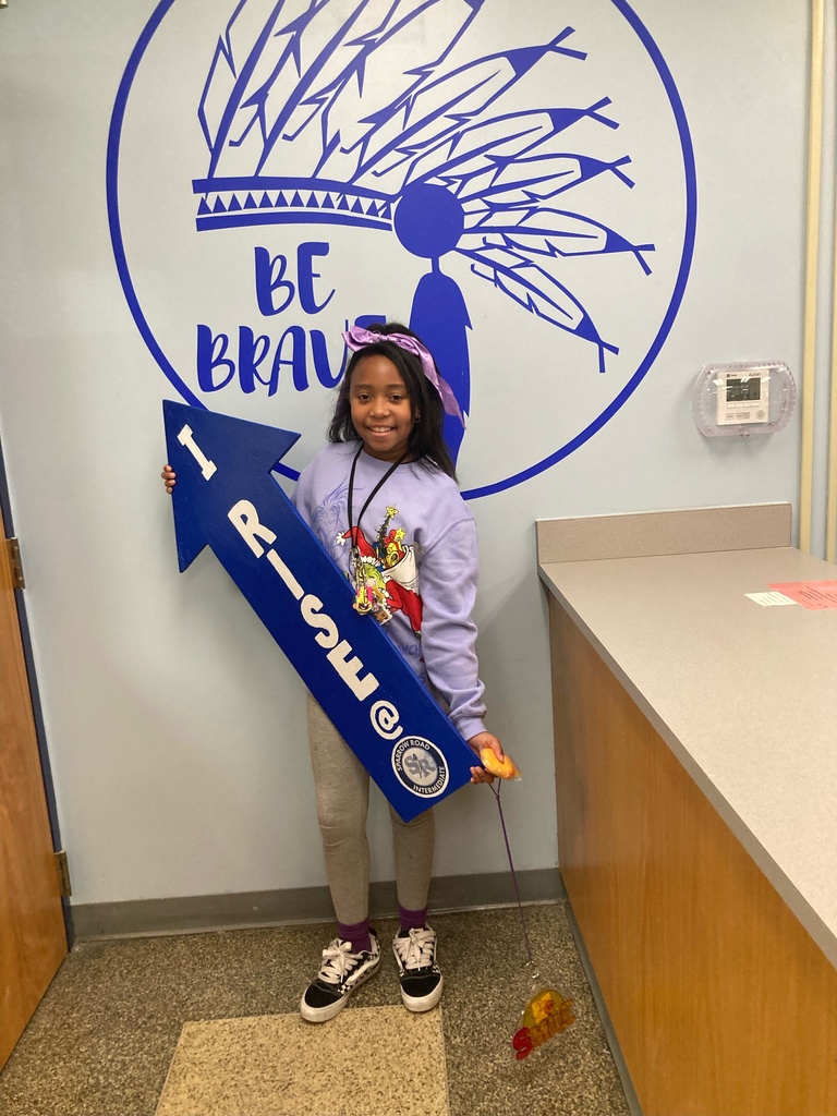 Student holding up I RISE sign