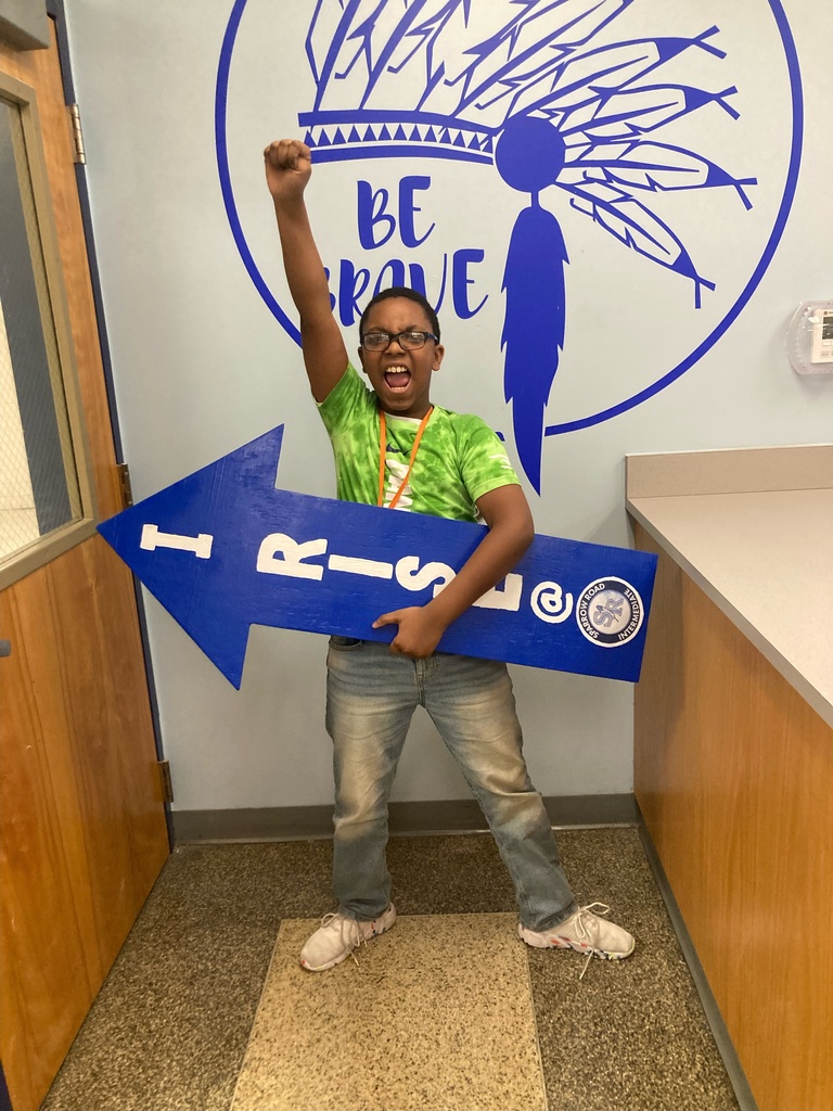 Student holding I RISE arrow with Hand in the air celebrating