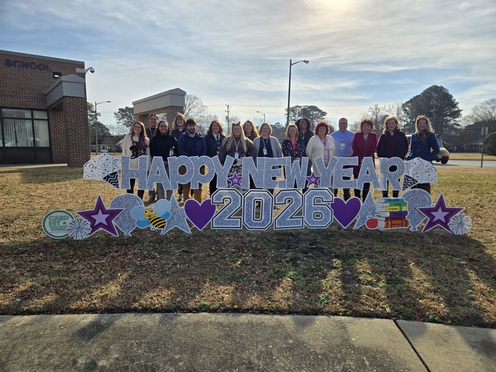 Teachers in front of our Happy New Year 2026 Sign.