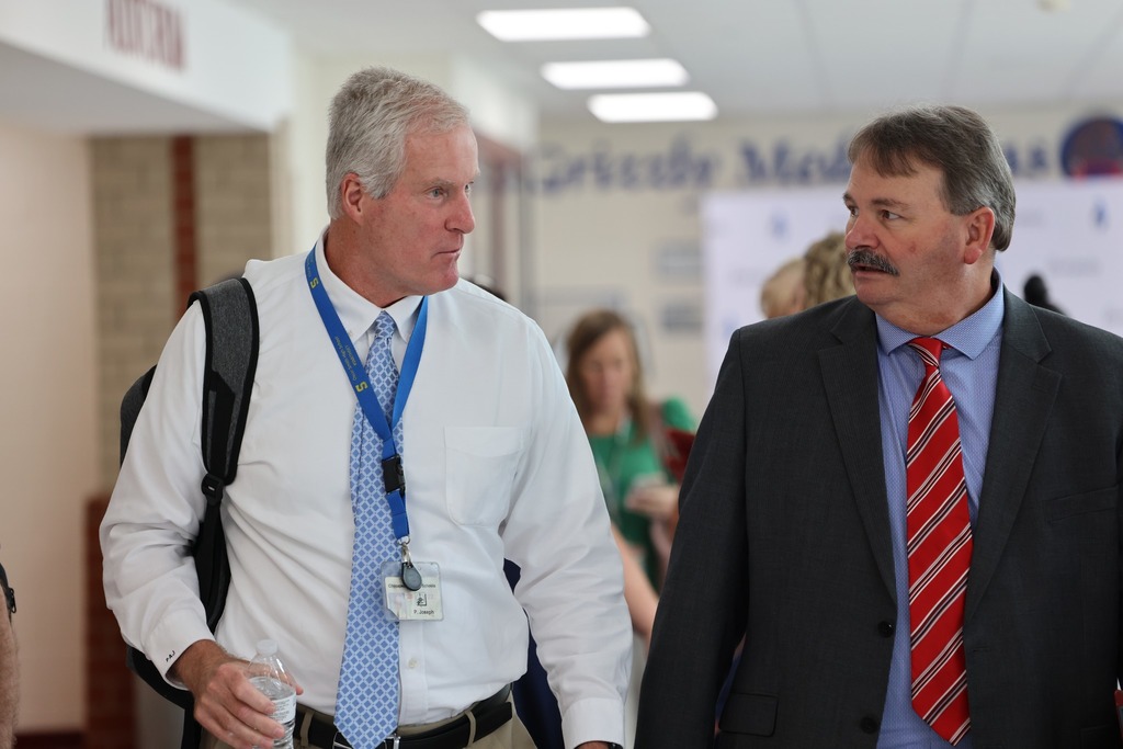two male high school prnicipals walking and talking