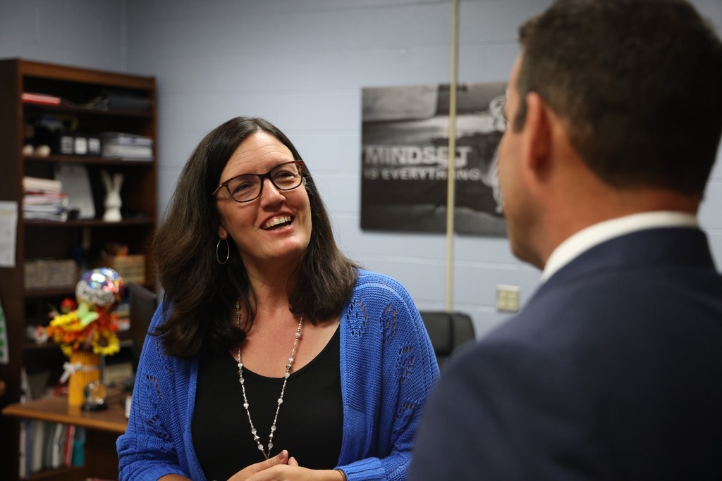 female principal smiling at school board member