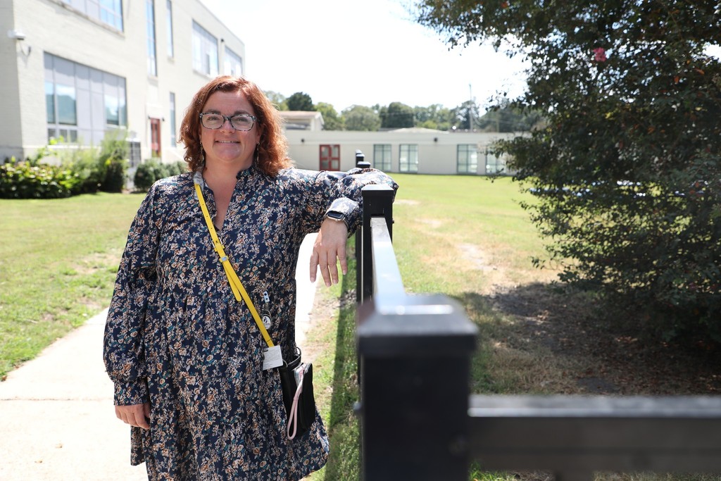 Ms. Coker smling outside school