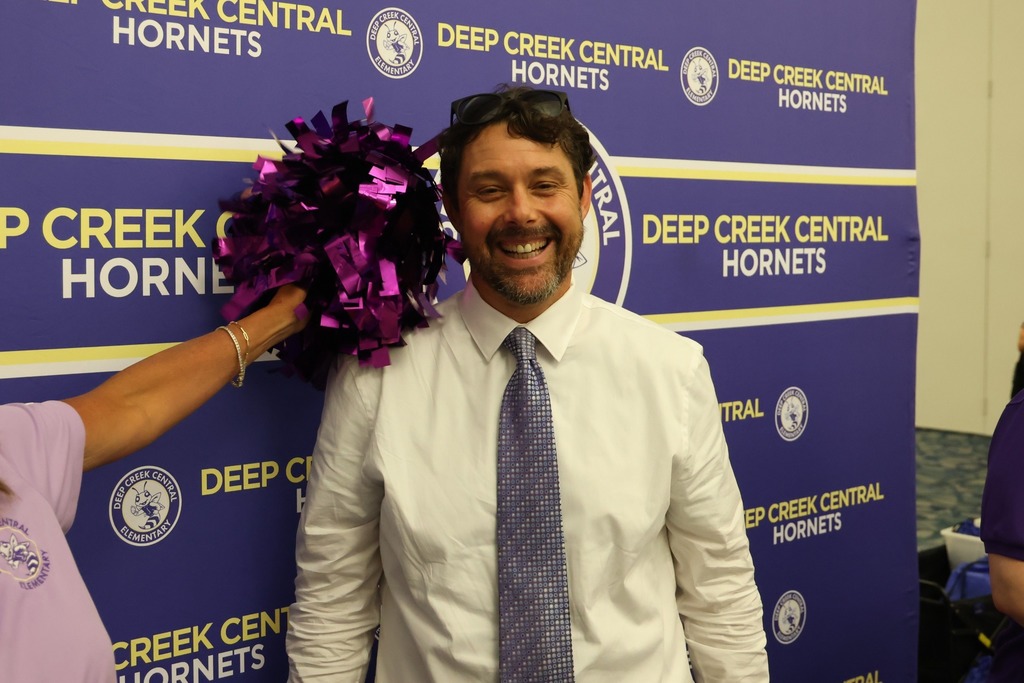 male principla smiling at camera