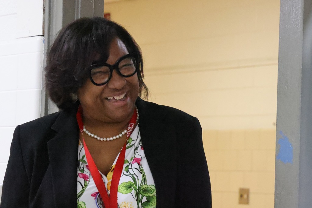 female principal smiling at camera