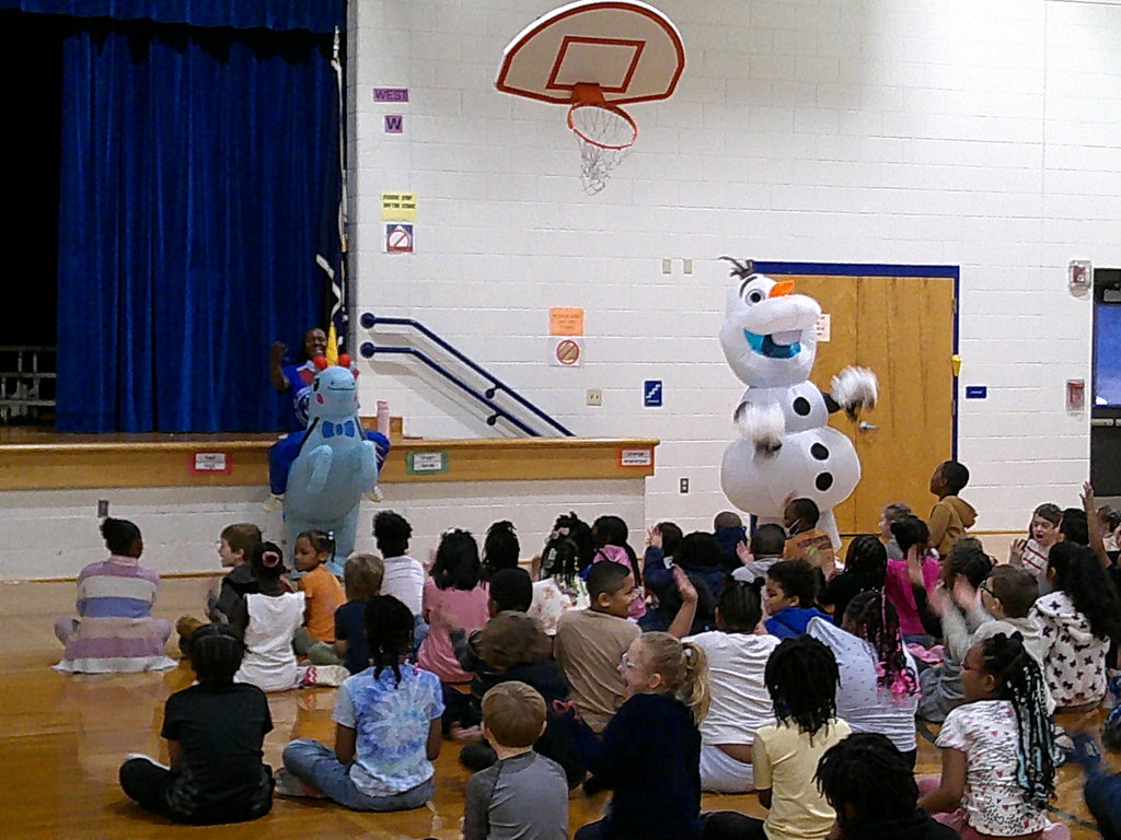 Mrs. Foard, Mrs. Gurkin, and 2nd grade students doing the secret hand signal - six seven!