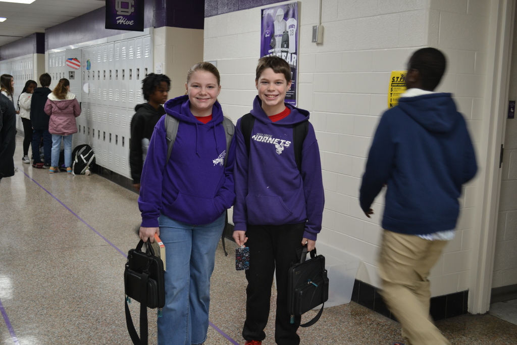 Two students twinning for Twin day wearing DCM sweatshirts