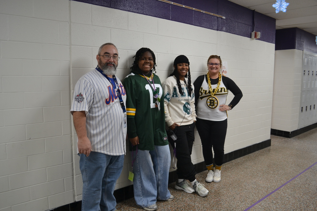 A student and teachers wearing their sports jersey.