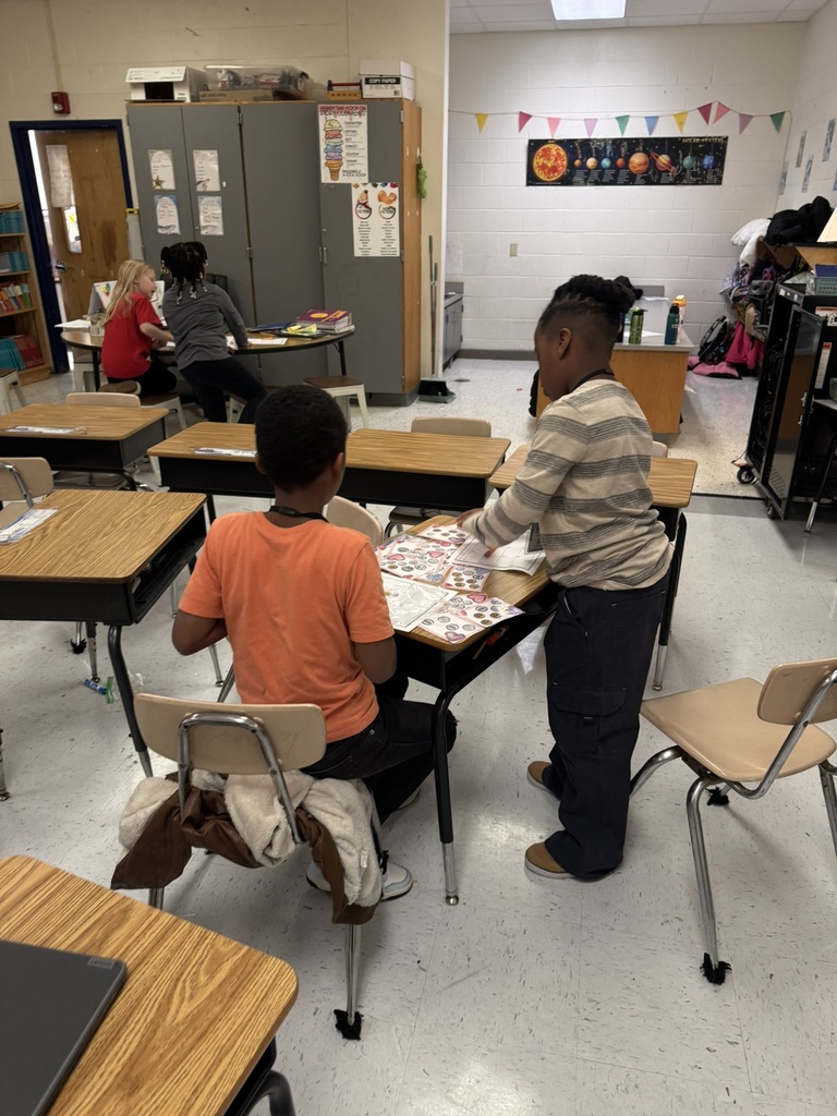 students work together on money activity