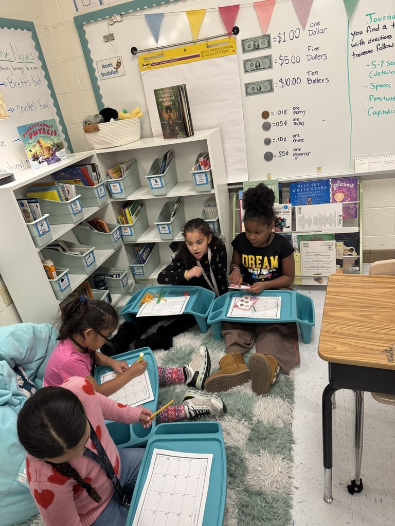 students work together on money activity