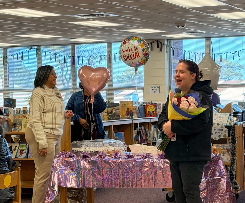 2 ladies smiling with balloons & 1 holding flowers