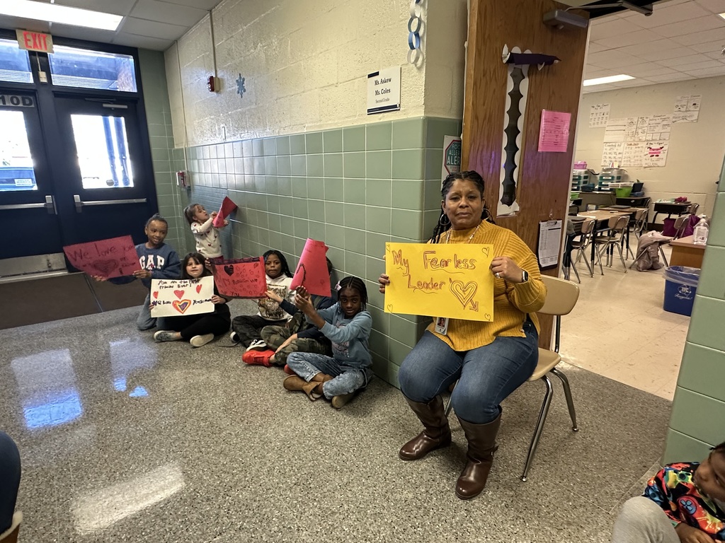 students with signs to celebrate the principal Mrs. robinson